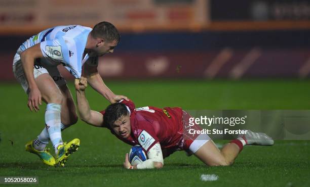 Racing fly half Finn Russell gets to grips with Scarlets wing Steffan Evans during the Champions Cup match between Scarlets and Racing 92 at Parc y...