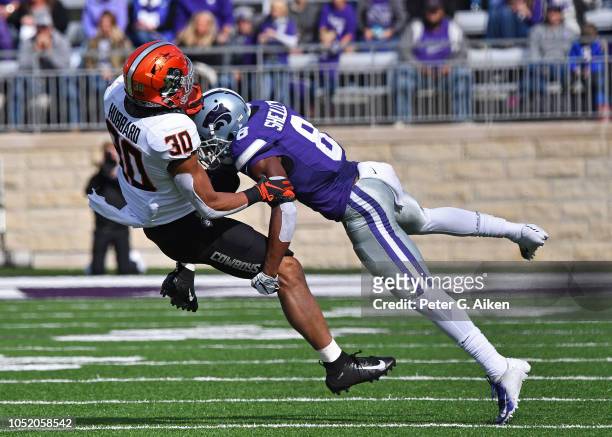 Defensive back Duke Shelley of the Kansas State Wildcats tackles running back Chuba Hubbard of the Oklahoma State Cowboys during the first half on...