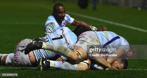 Racing number 8 Antonie Claassen can't stop Scarlets scrum half Gareth Davies from scoring their first try during the Champions Cup match between...