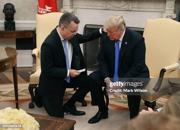 President Donald Trump and American evangelical Christian preacher Andrew Brunson participate in a prayer in the Oval Office a day after Brunson was...