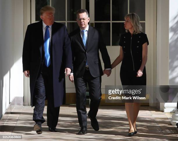 President Donald Trump , walks with American evangelical Christian preacher Andrew Brunson and his wife Norine Brunson, to a meeting in the Oval...
