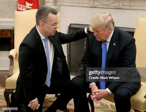 President Donald Trump and American evangelical Christian preacher Andrew Brunson participate in a prayer in the Oval Office a day after Brunson was...