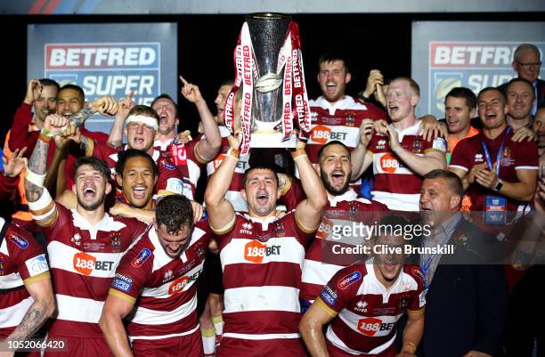 Ben Flower of Wigan Warriors celebrates with the trophy following victory in the BetFred Super League Grand Final between Warrington Wolves and Wigan...