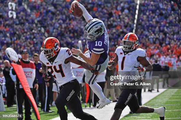 Quarterback Skylar Thompson of the Kansas State Wildcats makes a leaping attempt for the end zone between safety Jarrick Bernard and linebacker...