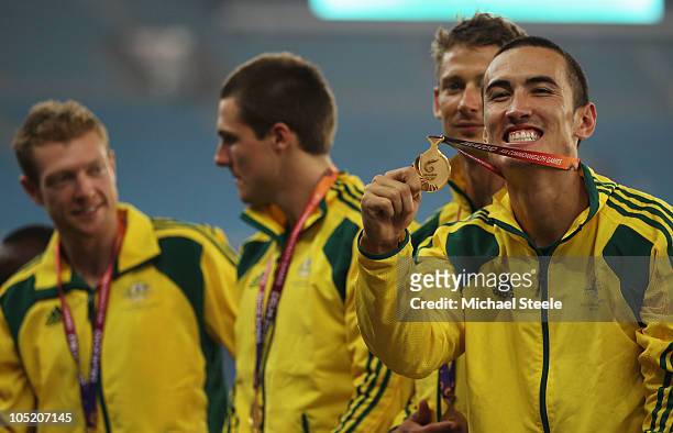 Gold medalists Joel Milburn, Kevin Moore, Brendan Cole and Sean Wroe of Australia celebrate on the podium with their medals after the men's 4 x 400...