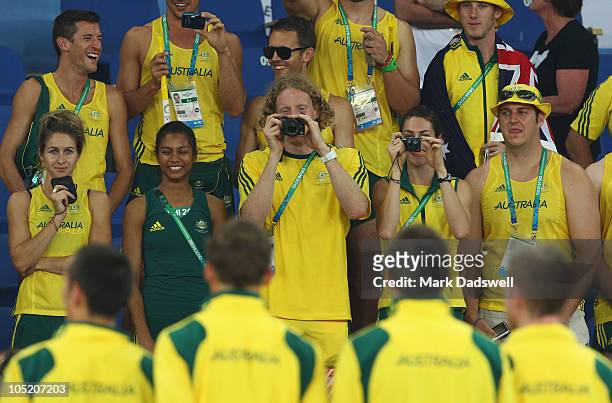 Members of the Australia team take photos of gold medalists Joel Milburn, Kevin Moore, Brendan Cole and Sean Wroe of Australia celebrate on the...