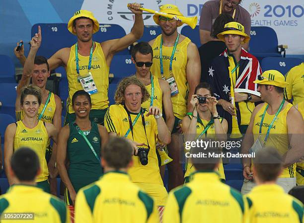 Members of the Australia team take photos of gold medalists Joel Milburn, Kevin Moore, Brendan Cole and Sean Wroe of Australia celebrate on the...