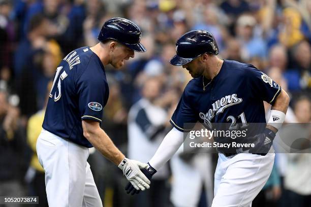 Travis Shaw of the Milwaukee Brewers celebrates with Erik Kratz after hitting a solo home run against Alex Wood of the Los Angeles Dodgers during the...