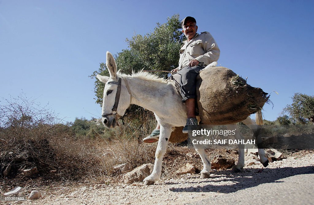 A farmer with carries a sack of freshly