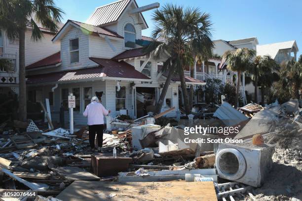 Peggy Wood walks through debris at her Driftwood Hotel that was damaged by Hurricane Michael on October 13, 2018 in Mexico Beach, Florida. Hurricane...