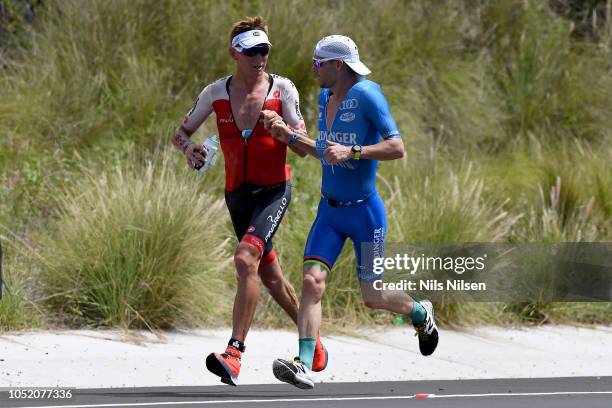Patrick Lange of Germany passes Cameron Wurf of Australia on the run during the IRONMAN World Championships brought to you by Amazon on October 13,...