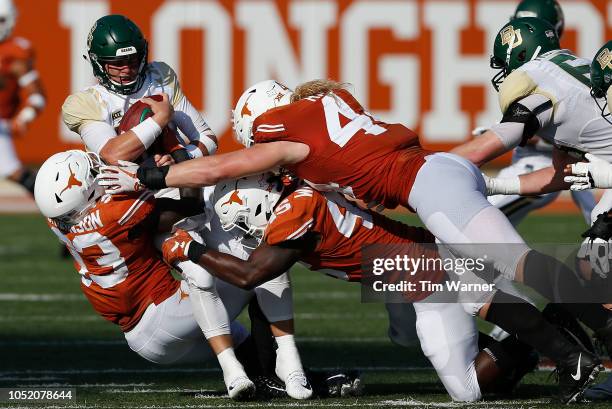 Charlie Brewer of the Baylor Bears is sacked by Gary Johnson of the Texas Longhorns and Anthony Wheeler in the second half at Darrell K Royal-Texas...