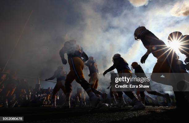 The California Golden Bears run out on to the field for their game against the UCLA Bruins at California Memorial Stadium on October 13, 2018 in...