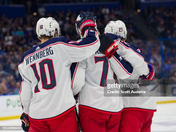 Josh Anderson of the Columbus Blue Jackets celebrates a goal with teammates Alexander Wennberg and Ryan Murray against the Tampa Bay Lightning during...
