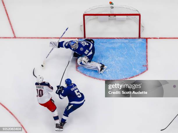 Goalie Andrei Vasilevskiy and Dan Girardi of the Tampa Bay Lightning battle against Alexander Wennberg of the Columbus Blue Jackets during the third...