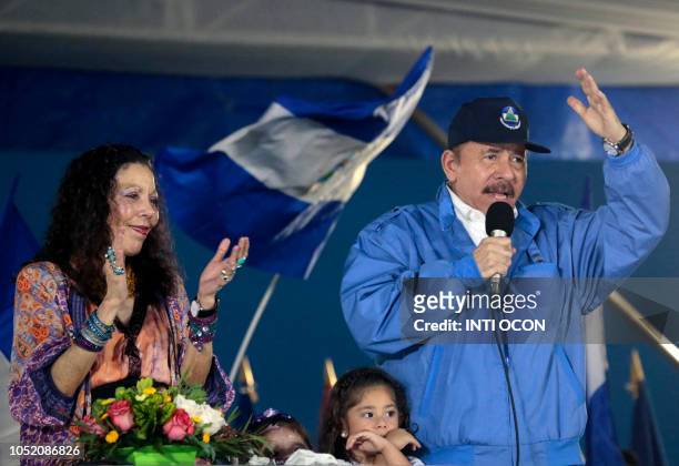 Nicaraguan President Daniel Ortega , speaks to supporters, next to his wife and Vice President Rosario Murillo, during a march called ¬We walk for...