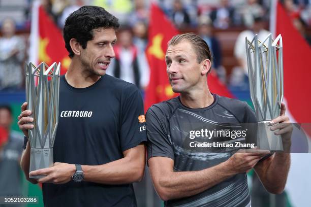 Lukasz Kubot of Poland and Marcelo Melo of Brazil celebrate with trophy during the Award Ceremony after winning the Men's doubles final match against...