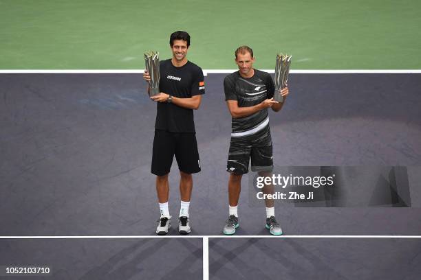 Lukasz Kubot of Poland and Marcelo Melo of Brazil celebrate with trophy during the Award Ceremony after winning the Men's doubles final match against...