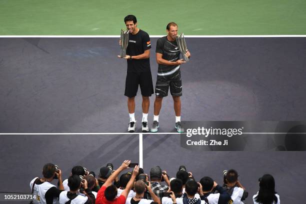 Lukasz Kubot of Poland and Marcelo Melo of Brazil celebrate with trophy during the Award Ceremony after winning the Men's doubles final match against...