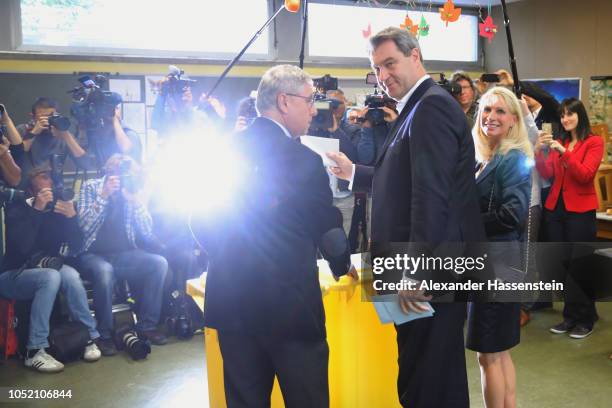 Markus Soeder, Governor of Bavaria and lead candidate of the Christian Social Union , and his wife, Karin Baumueller-Soeder, arrive to cast their...