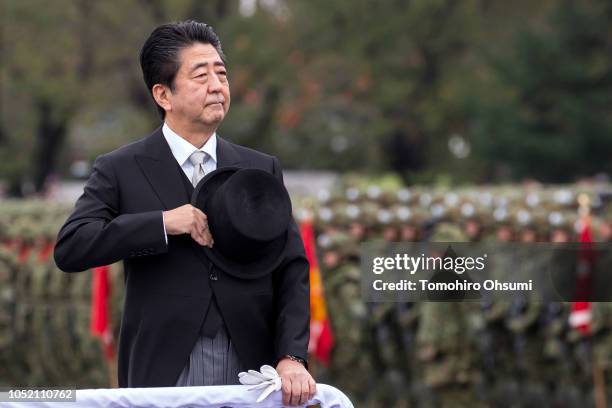 Japanese Prime Minister Shinzo Abe reviews troops of the country's Self Defense Forces during the annual review at the Japan Ground Self Defense...