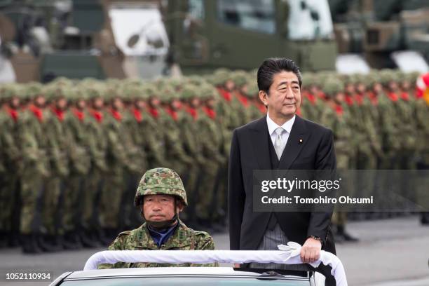 Japanese Prime Minister Shinzo Abe reviews troops of the country's Self Defense Forces during the annual review at the Japan Ground Self Defense...