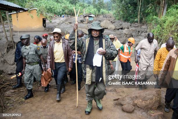 Uganda's President Yoweri Museveni visits to the flood-ravaged village of Wanjenwa, eastern Uganda, on October 14, 2018. At least 43 people were...