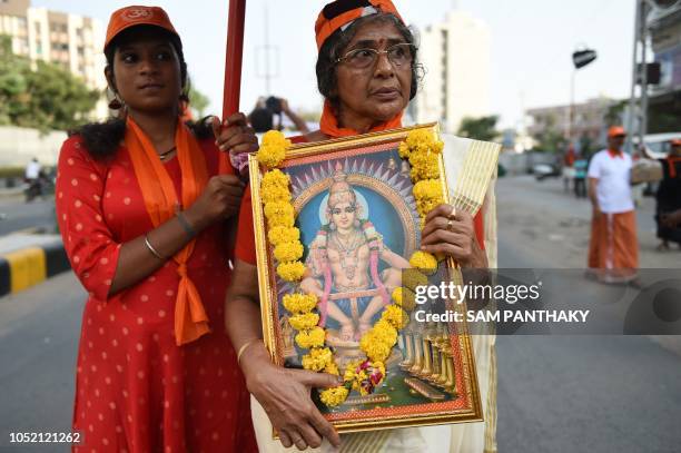 Indian Ayaappa devotees participate in a peaceful protest rally against the Supreme Court decision to allow women of all ages to enter inside the...