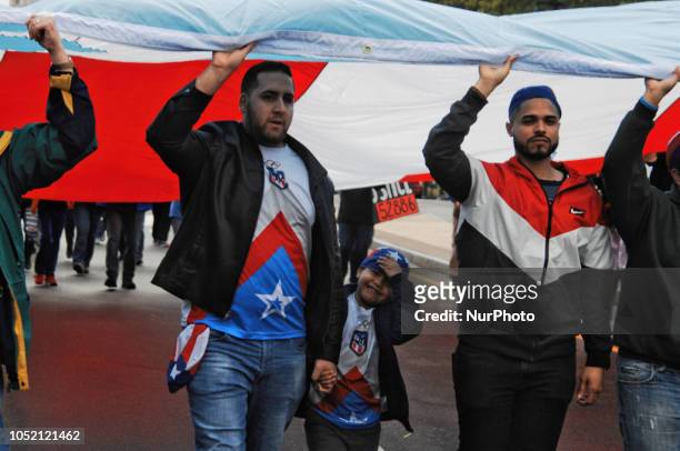 Puerto Rican Philadelphians and their supporters march to Remember Puerto Rican Victims of Colonialism in Philadelphia, PA, on 13 October 2018. They...