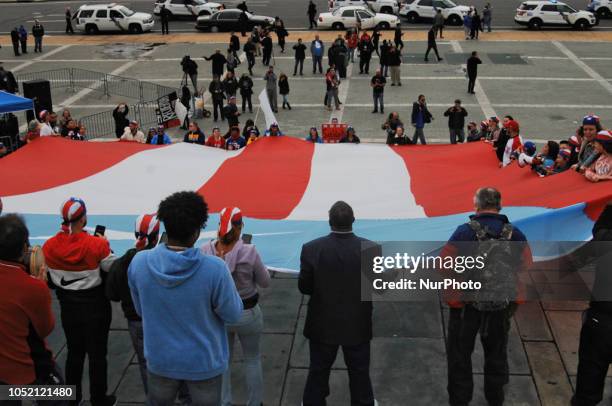 Puerto Rican Philadelphians and their supporters march to Remember Puerto Rican Victims of Colonialism in Philadelphia, PA, on 13 October 2018. They...