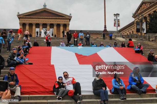 Puerto Rican Philadelphians and their supporters march to Remember Puerto Rican Victims of Colonialism in Philadelphia, PA, on 13 October 2018. They...