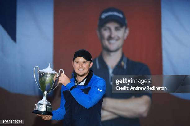 Eddie Pepperell of England pose for a photo with the trophy after winning the tournament during day four of Sky Sports British Masters at Walton...