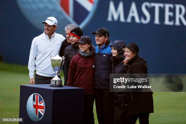 Eddie Pepperell of England pose for a photo with friends, family and host Justin Rose of England after winning the tournament during day four of Sky...