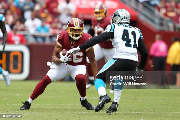 Tight end Jordan Reed of the Washington Redskins runs with the ball in the first quarter against Captain Munnerlyn Carolina Panthers at FedExField on...