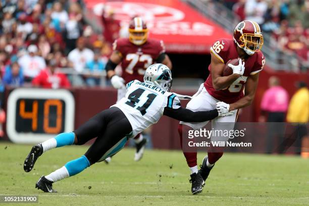 Tight end Jordan Reed of the Washington Redskins is tackled by defensive back Captain Munnerlyn of the Carolina Panthers in the first quarter at...