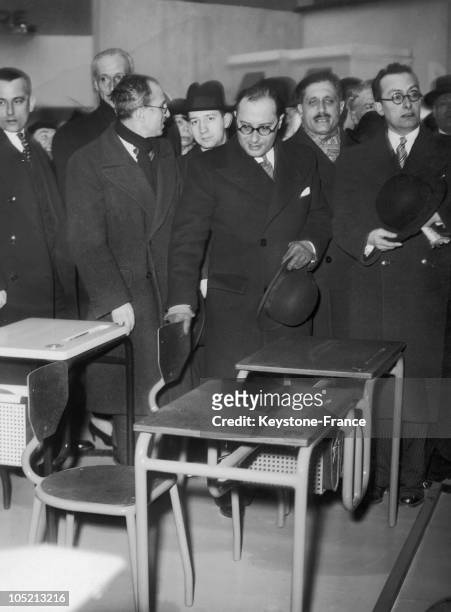 The French Minister Of National Education Jean Zay Examines New Desks Of Students In A Home Fair In Paris January 29, 1937.