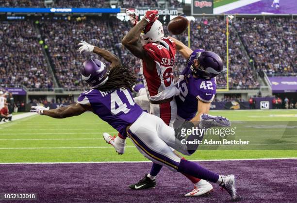 Ben Gedeon and Anthony Harris of the Minnesota Vikings break up a pass to Ricky Seals-Jones of the Arizona Cardinals in the second quarter of the...