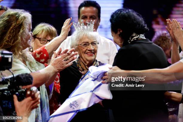 Holocaust survivor Tova Ringer celebrates after winning the annual Holocaust Survivors beauty pageant on October 14, 2018 in Haifa, Israel. The...