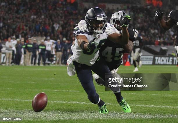 Doug Baldwin of Seattle Seahawks attempts to catch a pass from the Seattle Seahawks quarterback while being tackled by Dominique Rodgers-Cromartie of...