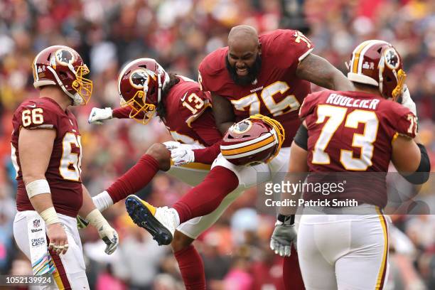 Offensive tackle Morgan Moses of the Washington Redskins and wide receiver Maurice Harris celebrate after the Carolina Panthers turned the ball over...