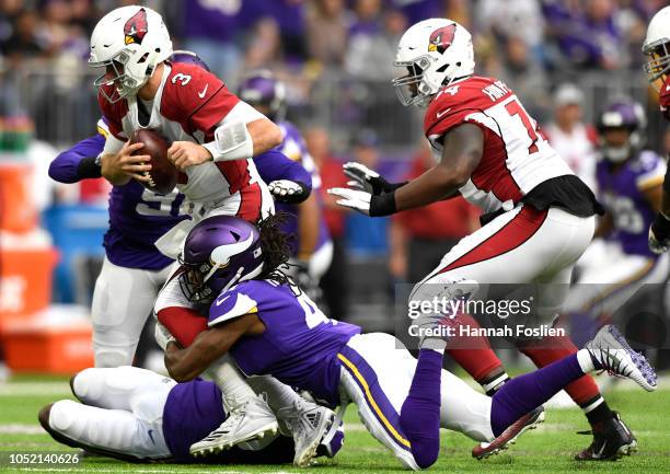 Josh Rosen of the Arizona Cardinals is sacked by Anthony Harris of the Minnesota Vikings in the first half of the game at U.S. Bank Stadium on...