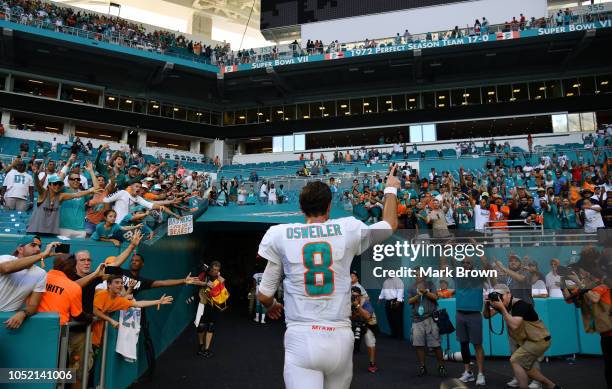 Brock Osweiler of the Miami Dolphins celebrates as he walks off of the field after the Dolphins defeated the Bears 31 to 28 of the game at Hard Rock...