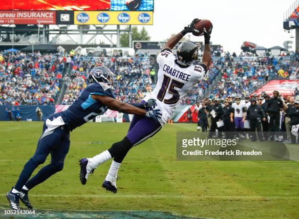 Michael Crabtree of the Baltimore Ravens catches a pass to score a touchdown in the first quarter while defended by Malcolm Butler of the Tennessee...