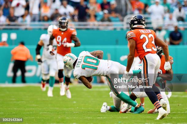 Kenny Stills of the Miami Dolphins completes a pass against the defense Adrian Amos and Kyle Fuller of the Chicago Bears at Hard Rock Stadium on...