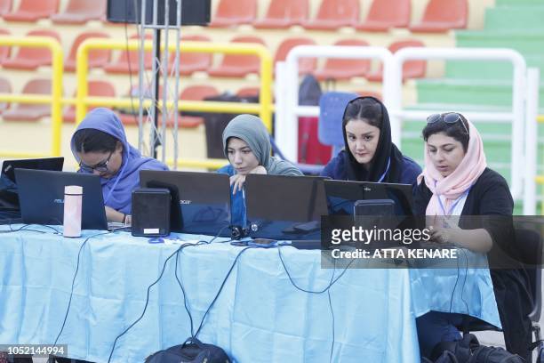 Iranian girls are trained to be journalists are covering street children sponsored by the Imam Ali Foundation during a football tournament in Tehran...