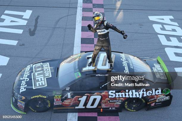 Aric Almirola, driver of the Smithfield Bacon for Life Ford, celebrates after winning the Monster Energy NASCAR Cup Series 1000Bulbs.com 500 at...