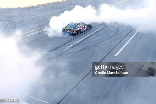 Aric Almirola, driver of the Smithfield Bacon for Life Ford, celebrates after winning the Monster Energy NASCAR Cup Series 1000Bulbs.com 500 at...