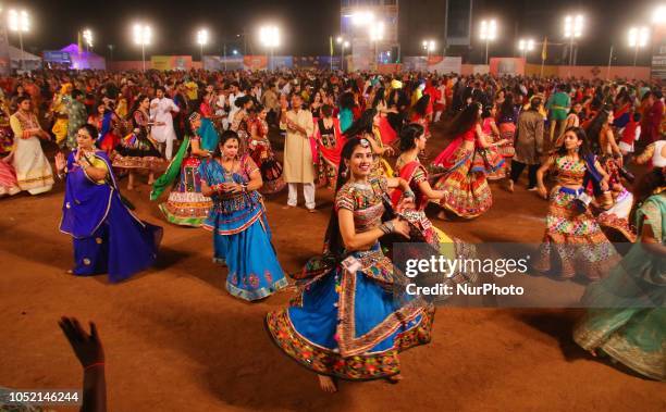 Indian men and women perform Garba &amp; Dandiya dance during the Navratri festival 'nine days' celebration in Jaipur,Rajasthan,India on Oct...