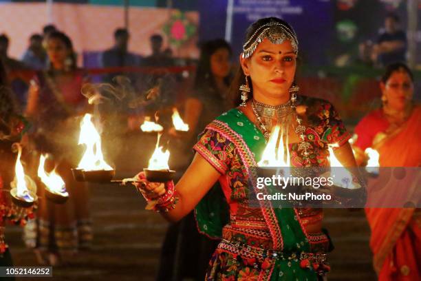 Indian men and women perform Garba &amp; Dandiya dance during the Navratri festival 'nine days' celebration in Jaipur,Rajasthan,India on Oct...