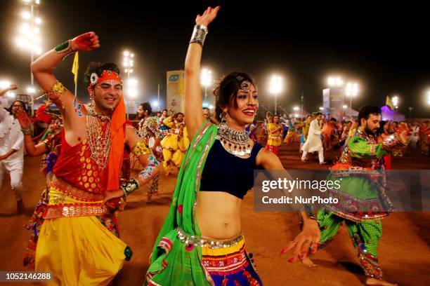 Indian men and women perform Garba &amp; Dandiya dance during the Navratri festival 'nine days' celebration in Jaipur,Rajasthan,India on Oct...